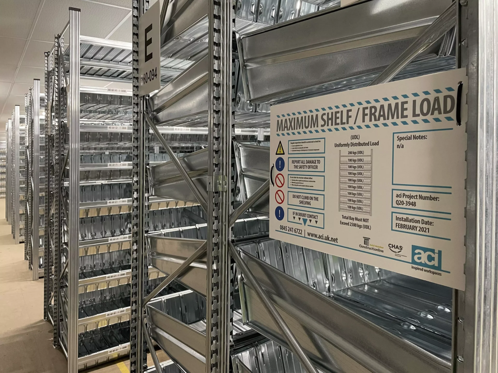 Unirack shelving installation showing maximum shelf and frame load signage fixed to the end of a storage bay.